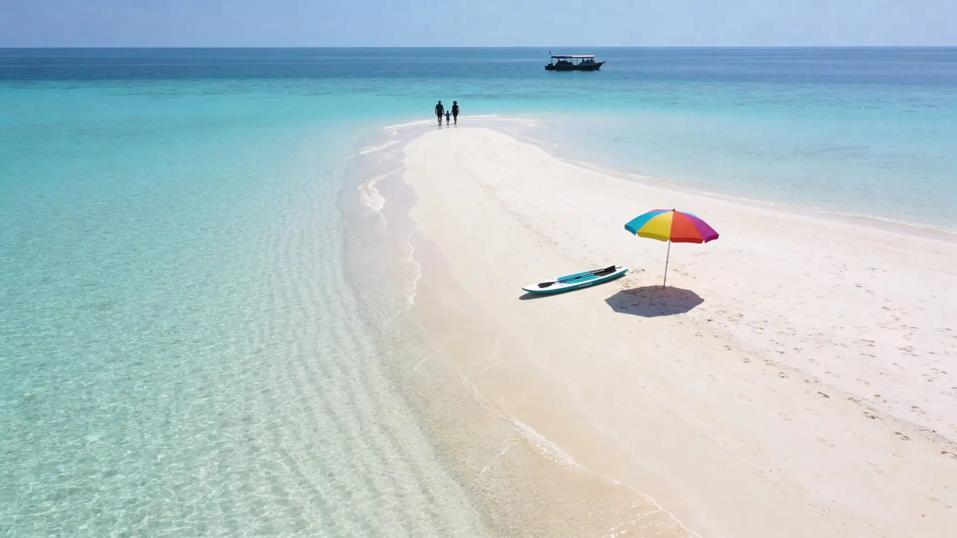 Best Beaches In Nassau Bahamas Near Cruise Ship Port 1 A small sandy island in turquoise waters with a family walking and a colorful beach umbrella nearby.